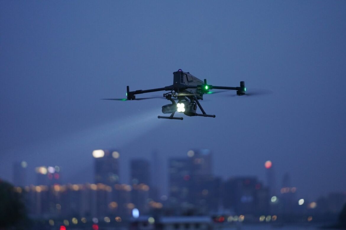 Drone flying in the urban night sky.