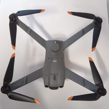 Grey drone with black orange propellers on a white background.