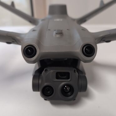 Close-up view of a gray drone with cameras.