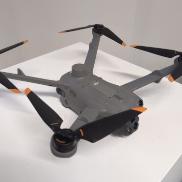 Grey drone with four propellers on a white background.