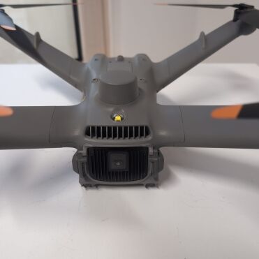 Gray drone on a white surface.