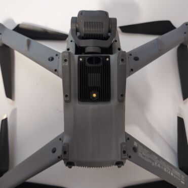 Top view of a gray drone on a white background.