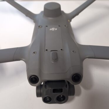 Grey drone with cameras on a white table.